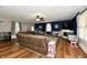 Cozy living room with a large leather sectional sofa, TV, and neutral décor at 8543 W County Road 600 S, Coatesville, IN 46121
