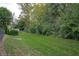 Spacious backyard features a lush green lawn, perfect for outdoor activities and enjoying the natural surroundings at 8737 Chateaugay Dr, Indianapolis, IN 46217