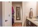 Bathroom with a granite countertop, wood cabinets, towel, and view through a doorway at 8737 Chateaugay Dr, Indianapolis, IN 46217