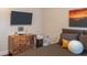 Modern bedroom featuring a wooden dresser, a TV, and a comfortable bed with accent pillows at 8737 Chateaugay Dr, Indianapolis, IN 46217