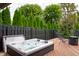 Relaxing backyard hot tub on wood deck with string lights and landscaping providing a private outdoor retreat at 8737 Chateaugay Dr, Indianapolis, IN 46217