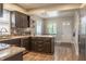 Open kitchen area with granite countertops, stainless steel appliances, and an adjacent dining space at 8737 Chateaugay Dr, Indianapolis, IN 46217