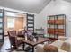 Comfortable living room with hardwood floors, modern shelving, and sliding doors leading to another room at 8737 Chateaugay Dr, Indianapolis, IN 46217