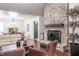 Stylish living room with a brick fireplace, hardwood floors, comfortable seating, and elegant dining room at 8737 Chateaugay Dr, Indianapolis, IN 46217