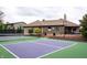 Tennis court, landscaping and deck overlooking the yard at 8737 Chateaugay Dr, Indianapolis, IN 46217