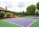 Tennis court adjacent to a deck overlooking the backyard and landscaping at 8737 Chateaugay Dr, Indianapolis, IN 46217