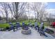 Spacious backyard patio area with a stone fire pit and comfortable lounge seating arrangement at 10047 Perlita Pl, Fishers, IN 46038