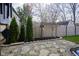 Landscaped backyard features a stone path, mature trees, and lush greenery at 10047 Perlita Pl, Fishers, IN 46038