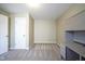 An empty bedroom with built in desk and shelving with carpet and a white door at 10047 Perlita Pl, Fishers, IN 46038