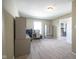 An office in a large bedroom featuring carpeted floors, natural light, and built in desk and cabinetry at 10047 Perlita Pl, Fishers, IN 46038