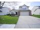 Charming two-story home with a two-car garage and well-maintained lawn and landscaping at 10047 Perlita Pl, Fishers, IN 46038