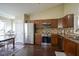 Open concept kitchen with stainless steel appliances and dark wood floors at 10047 Perlita Pl, Fishers, IN 46038