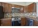 Updated kitchen showcasing stainless steel oven and microwave over granite countertops at 10047 Perlita Pl, Fishers, IN 46038