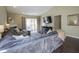 An inviting living room with a cozy sectional sofa, fireplace, and view of the backyard at 10047 Perlita Pl, Fishers, IN 46038