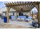 Relaxing backyard patio beneath a wooden pergola with comfortable seating and an outdoor living space at 10047 Perlita Pl, Fishers, IN 46038