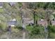 An aerial view shows a home with mature trees, a driveway, and manicured lawns in a serene neighborhood at 10129 Guilford Ave, Carmel, IN 46280