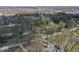 An aerial view showcases a community nestled amongst mature trees and serene surroundings at 10129 Guilford Ave, Carmel, IN 46280