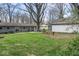 Large backyard featuring mature trees, green grass and an outbuilding at 10129 Guilford Ave, Carmel, IN 46280