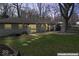 Backyard featuring a patio with string lights, grass and mature trees at 10129 Guilford Ave, Carmel, IN 46280