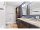 Renovated bathroom featuring a double vanity, tiled floor, and modern finishes at 10129 Guilford Ave, Carmel, IN 46280
