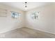 Bedroom with neutral carpet and two windows that offer a view of the outside at 10129 Guilford Ave, Carmel, IN 46280