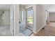 Bright entryway featuring hardwood floors and a decorative front door at 10129 Guilford Ave, Carmel, IN 46280