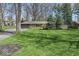 Beautifully landscaped front yard with lush green grass and mature trees at 10129 Guilford Ave, Carmel, IN 46280