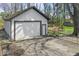 A single-car detached garage with white siding and an adjacent outdoor living space at 10129 Guilford Ave, Carmel, IN 46280