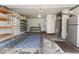 Organized garage featuring shelving, a refrigerator, and ample storage space at 10129 Guilford Ave, Carmel, IN 46280
