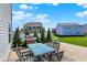 Spacious backyard featuring a patio set, grill, and green grass at 10465 Long Branch Dr, Brownsburg, IN 46112