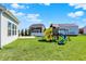 Spacious backyard with patio, playset, and manicured lawn at 10465 Long Branch Dr, Brownsburg, IN 46112