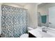 This bathroom has a patterned shower curtain, a toilet, sink and mirror at 10465 Long Branch Dr, Brownsburg, IN 46112