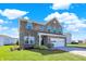 Attractive two-story brick home with a green lawn and a two-car garage on a sunny day at 10465 Long Branch Dr, Brownsburg, IN 46112