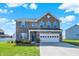 Charming two-story brick home with a well-manicured lawn and a two-car garage at 10465 Long Branch Dr, Brownsburg, IN 46112