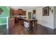 Bright kitchen with stainless steel appliances, large island, and dark wood floors at 10465 Long Branch Dr, Brownsburg, IN 46112