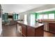 Spacious kitchen with a large island, stainless steel dishwasher, and dark wood floors at 10465 Long Branch Dr, Brownsburg, IN 46112