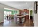 Open concept kitchen with stainless appliances, large island and a view to the dining area at 10465 Long Branch Dr, Brownsburg, IN 46112