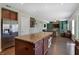 Well-lit kitchen with stainless steel refrigerator and a view into the living room at 10465 Long Branch Dr, Brownsburg, IN 46112
