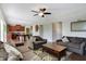 Inviting living room featuring a comfortable sofa, chairs, and a ceiling fan at 10465 Long Branch Dr, Brownsburg, IN 46112
