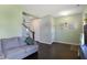 Comfortable living room featuring wood floors, staircase access, and neutral wall colors at 10465 Long Branch Dr, Brownsburg, IN 46112