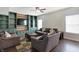 Spacious living room boasts a wood accent wall, custom built-ins, and cozy seating at 10465 Long Branch Dr, Brownsburg, IN 46112
