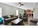 Spacious living room open to the kitchen, featuring dark wood floors and comfortable seating at 10465 Long Branch Dr, Brownsburg, IN 46112
