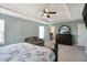 Bright bedroom with a walk in closet and dresser; the room has a tray ceiling and neutral walls at 10465 Long Branch Dr, Brownsburg, IN 46112