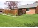 Backyard featuring a lawn, garden area with plants, and a partial privacy fence at 1121 Canterbury Ct, Indianapolis, IN 46260