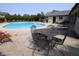 Enjoy the community pool with lounge chairs, tables, and benches surrounding the sparkling blue water on a sunny day at 1121 Canterbury Ct, Indianapolis, IN 46260