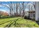 Spacious backyard with a large, well-maintained lawn, wooden fence and screened-in porch at 11249 Tall Trees Dr, Fishers, IN 46038