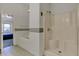 Bright bathroom featuring a shower stall and a tub with a decorative border at 11249 Tall Trees Dr, Fishers, IN 46038