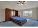 Spacious bedroom with vaulted ceiling, ceiling fan, and built-in wooden cabinetry at 11249 Tall Trees Dr, Fishers, IN 46038