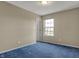 Bright bedroom with blue carpet, neutral walls, and natural light creating a welcoming and comfortable space at 11249 Tall Trees Dr, Fishers, IN 46038