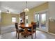 Light-filled dining area off the kitchen features a wood table set, a brick fireplace, and sliding glass doors at 11249 Tall Trees Dr, Fishers, IN 46038